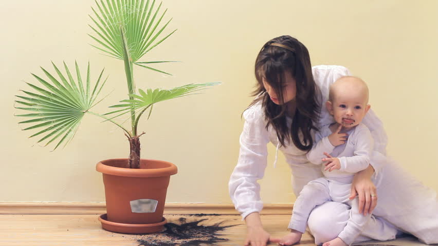 Mother cleaning baby's mess