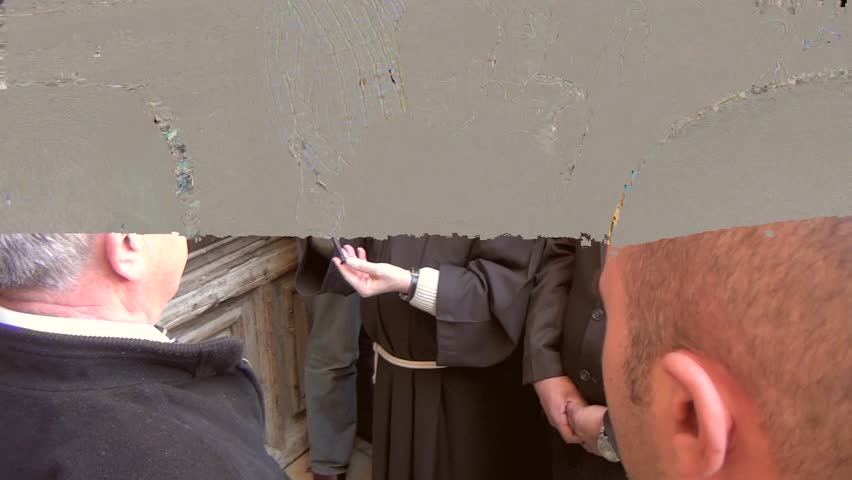 JERUSALEM-MARCH 28:Catholic priest wait to opening the door of the Temple,with key keeper,before entering the Latin Patriarch to Holy Sepulcher,on Holy Thursday March 28, 2013 in Jerusalem, Israel.
