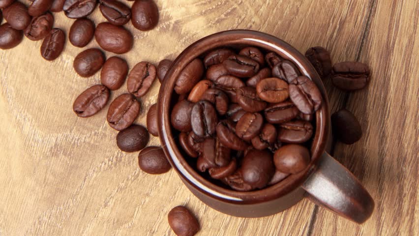 coffee beans and brown ceramic cup
