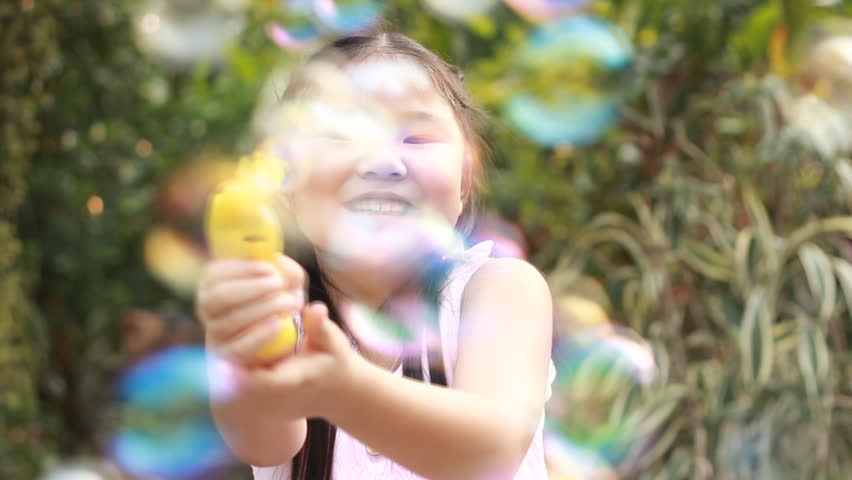 A  Little Girl Playing with Soap Bubbles, Outdoor Having Fun
