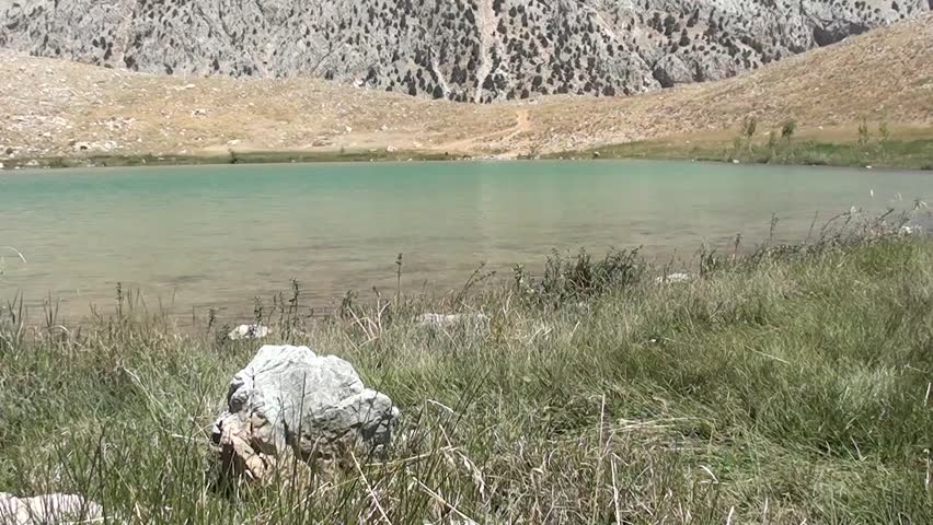 Mysterious Green crater lake in hot summer day,  breath-taking panorama