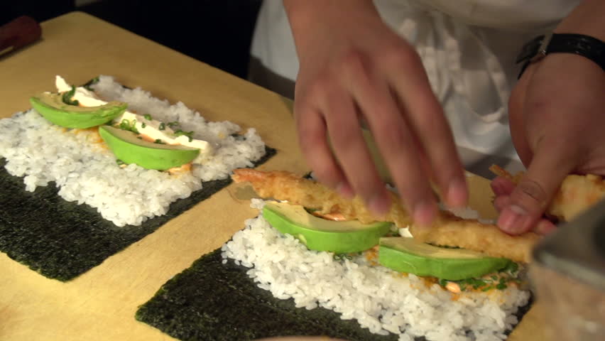 Sushi chef making a sushi roll