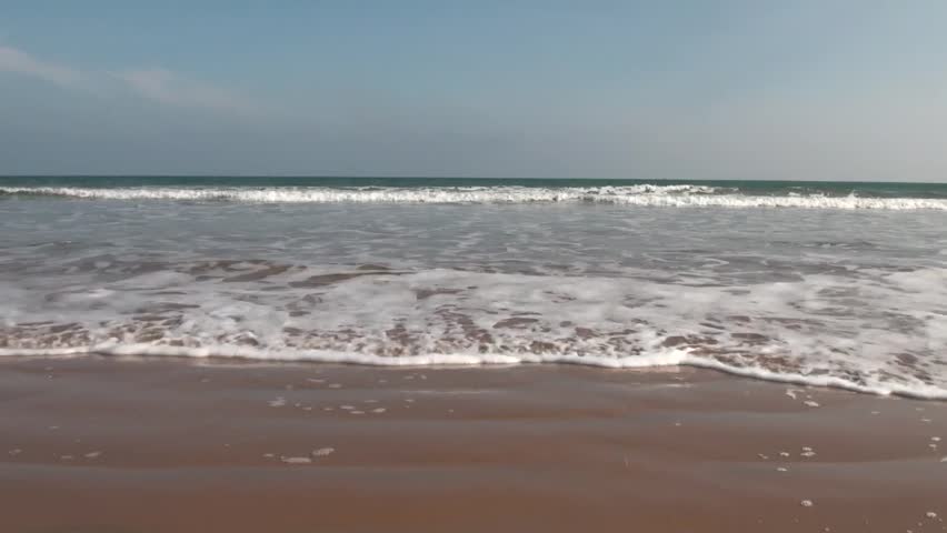 Ocean Waves and Beach: The waves from the sea of Bay of Bengal  come rushing to the coast in Chirala town of Andhra Pradesh, India.
