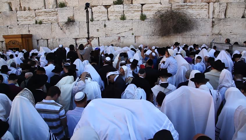 JERUSALEM, ISRAEL -  MARCH 28: Cohanim raise their hands during Priestly Blessing  (Hebrew - Birkat Cohanim) at the Western Wall plaza during the Passover Holiday, March 28 2013 in Jerusalem, Israel.
