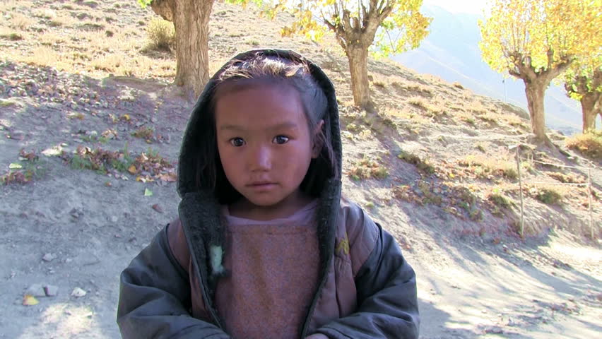 ANNAPURNA REGION, NEPAL â CIRCA OCTOBER 2011 â Little refugee tibetan girl looking to the camera circa October 2011 in Annapurna region in Nepal.