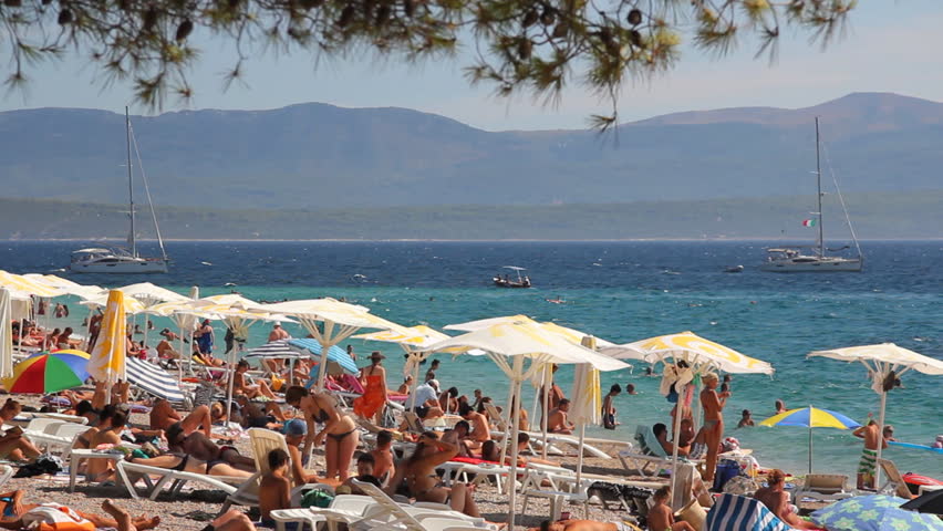 ISLAND BRAC, CROATIA - AUGUST 3. 2012. People on the beach, sunbathe and enjoy on vacation. Summertime at Adriatic Sea