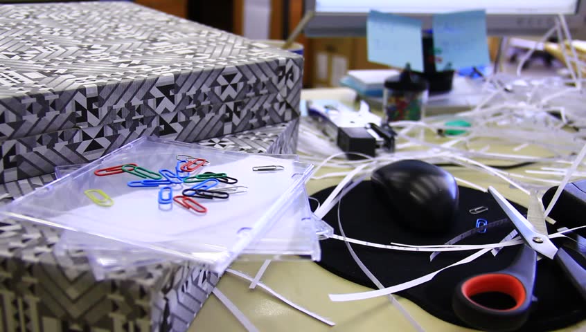 Chaotic office with all sorts of supplies and food. A bad worker, lazy person.