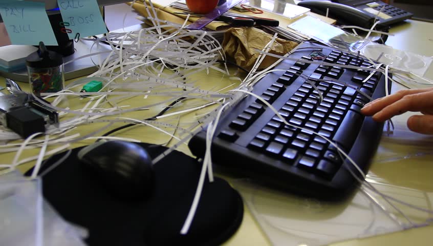 Lazy worker typing. Messy office.