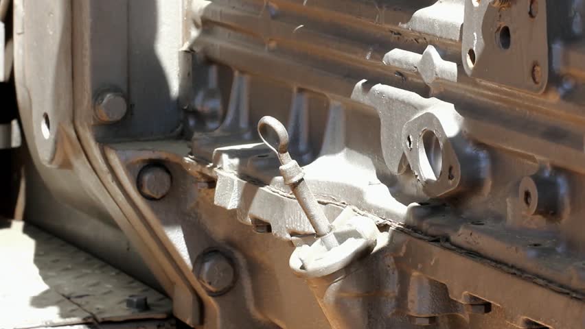 Male Hand Slowly Removes Old Diesel Engine Oil Dipstick