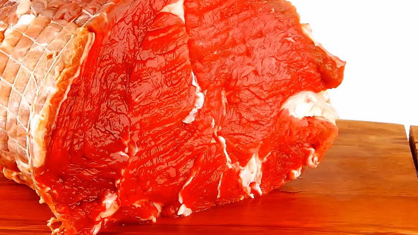 raw bloody beef meat on cutting plate