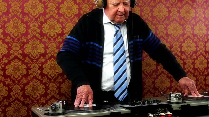 a very funky elderly grandpa dj mixing records
