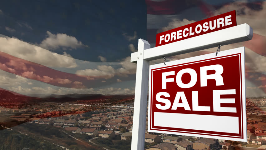 Foreclosure For Sale Real Estate Sign with Time-lapse Clouds and American Flag Ghosted with Neighborhood Below.