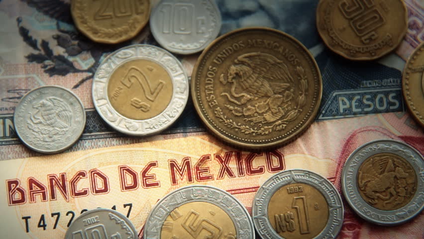 Mexican Pesos 3. Mexican paper money and metal coin currency. Blurred and goes into focus, quickly.