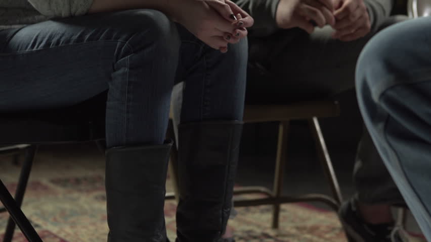 Young woman talking about her problems to support group