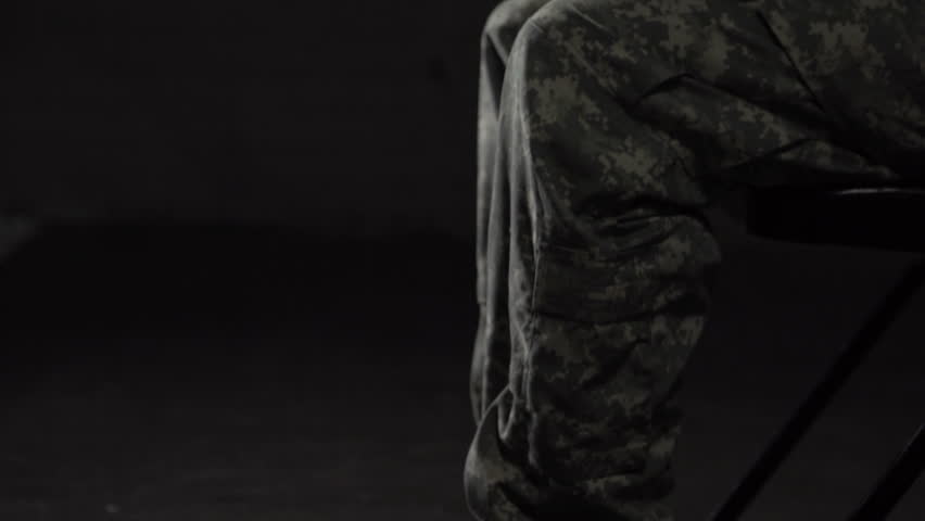 Young military woman struggling with Post Traumatic Stress Disorder