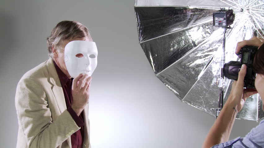 Photographer captures images of the actor/celebrity behind the mask. Edgy, hand-held camera in studio.