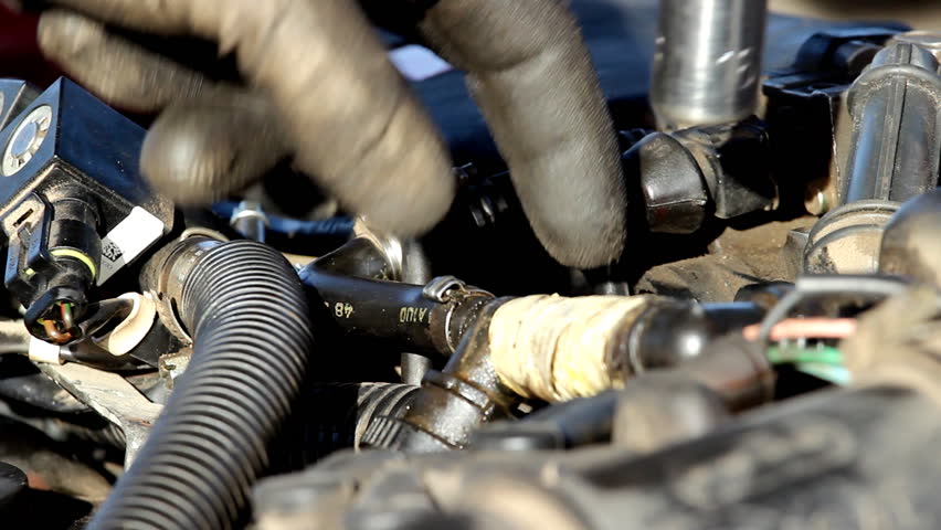 Dirty job - Mechanic fixing the car.