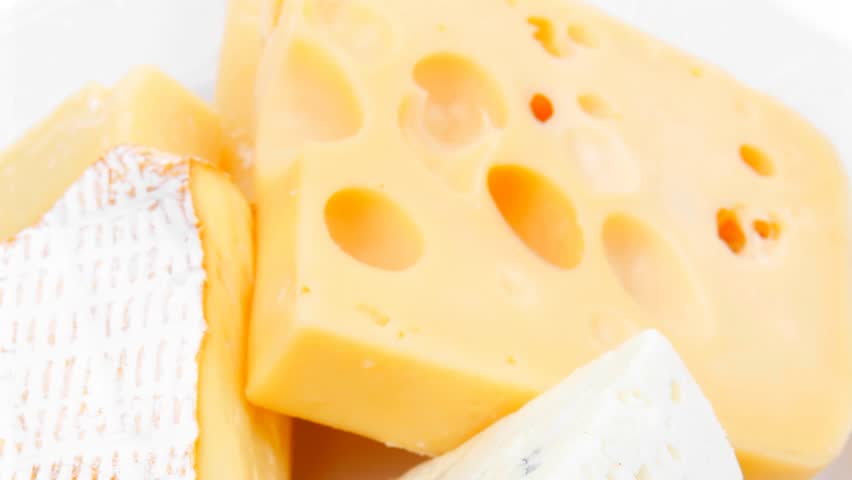 solid french cheese parmesan brie and edam on white platter isolated on white background