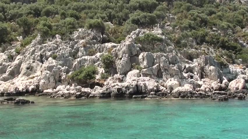 Picturesque view shot on the go from boat: the sea, cliffs, vegetation