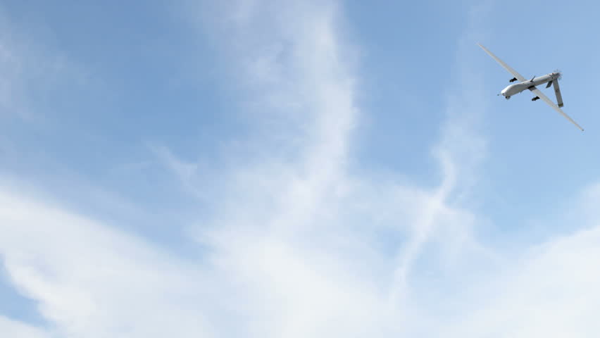 A Predator drone armed with Hellfire missiles veering and flying off to one side. (3d animation)