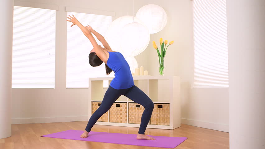 Chinese woman doing yoga pose: Warrior I