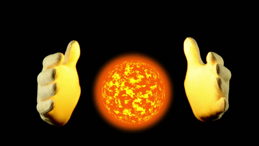Black background. The fiery sphere in weightlessness. Human hands in gloves govern the movement of the fiery sphere