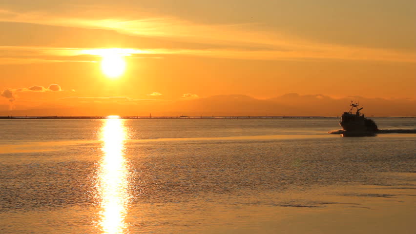 Crab Boat Returning at Sunset, Steveston. A crab boat returning to the Fraser River and Steveston from Georgia Strait at sunset. Near Vancouver, British Columbia, Canada.