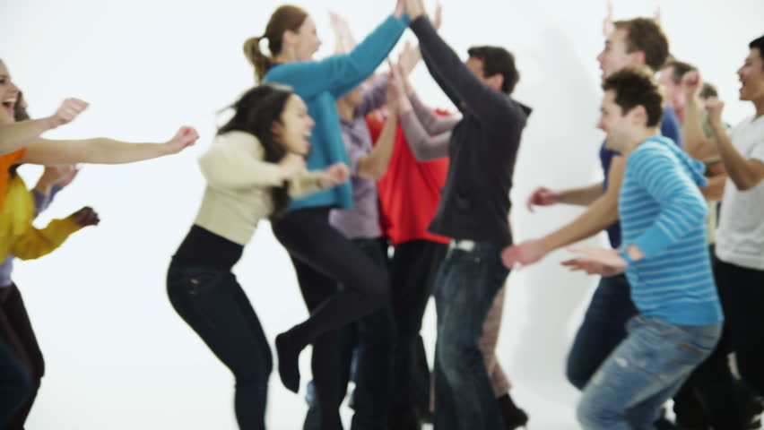 A happy and diverse multi ethnic group of people in colorful casual clothing run towards each other in a long line, cheering and celebrating. Isolated on white in a studio shot. In slow motion.