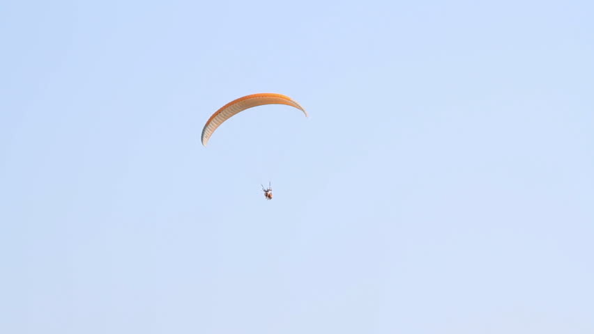Paragliding over the mountains against clear blue sky