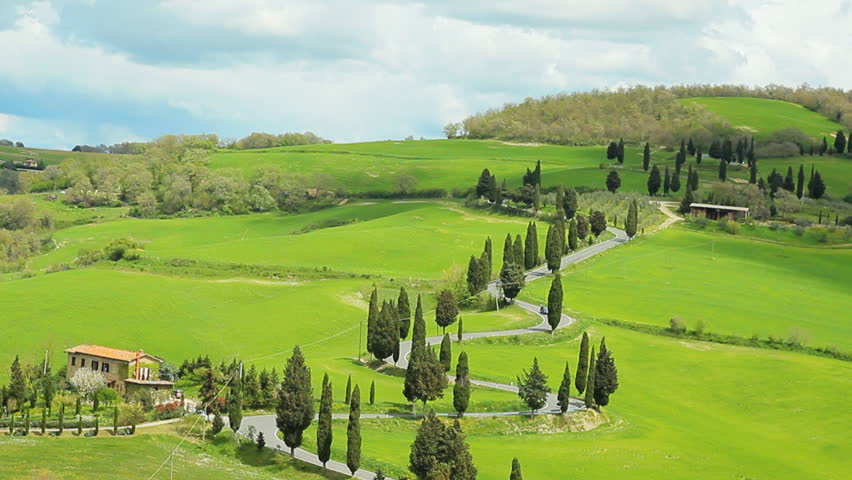 winding road with cypresses beside in tuscany val d'orcia montepulciano crane shot