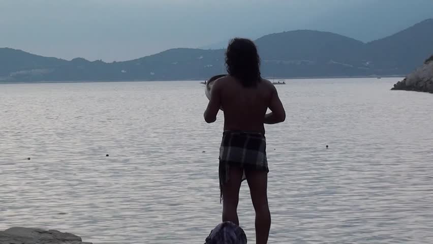 KAS, TURKEY â 12 August 2012: Aboriginal music concert at the Buyuk Cakil Beach - A man is singing OM and shivah, playing tambourine, audio
