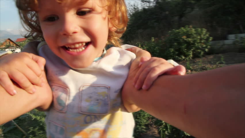 Happy Childhood. Father turns in son's hands