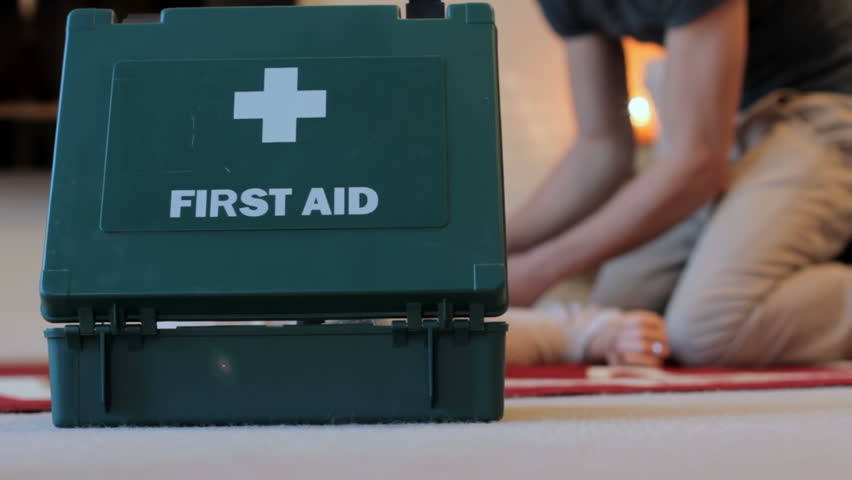 First Aid - A man runs in with a first aid kit to help a young woman who has collapsed