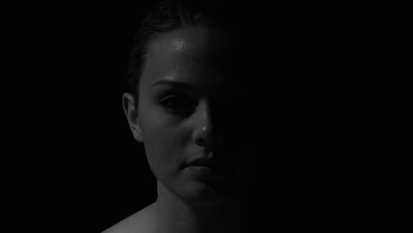 Woman's face in black and white. Experimental lighting