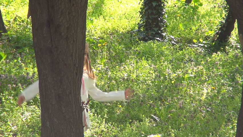 Little Girl Hiding behind Tree, Child Playing Hide and Seek in Forest, Children