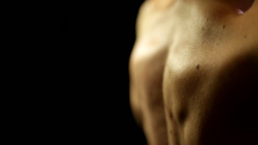 Young man doing weightlifting of shoulder muscles at home. Close-up of his muscles while lifting. High Quality.
