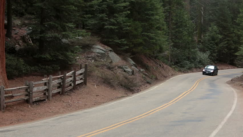 Car drive through Sequoia National Park California. Sierra Nevada mountains.  Established in 1890. The park spans 404,063 acres. The park is famous for its giant sequoia trees, worlds largest.