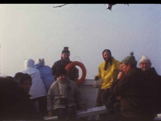 HELGOLAND, GERMANY - CIRCA 1970s: Group of people on boat take trip to Helgoland, Germany circa 1970s. Vintage 8mm film.