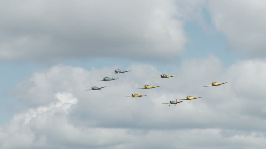 USAF T-6 Texans flying in formation with Canadian Air Force Harvards, small training aircraft from WWII.