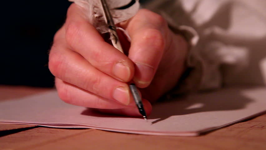 man writes a letter with quill pen