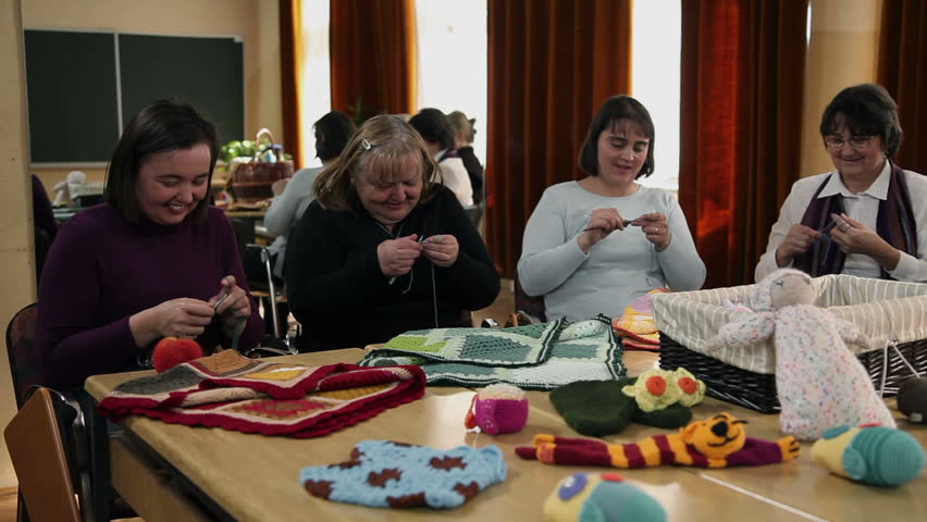 Old women knitting and old man watching