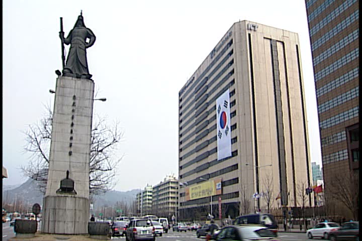 SEOUL - FEBRUARY 26, 1997: Day time b-roll of Jung-gu section of Seoul; WS Sejong Avenue with statue of Admiral Yi Sun Sin in center. 