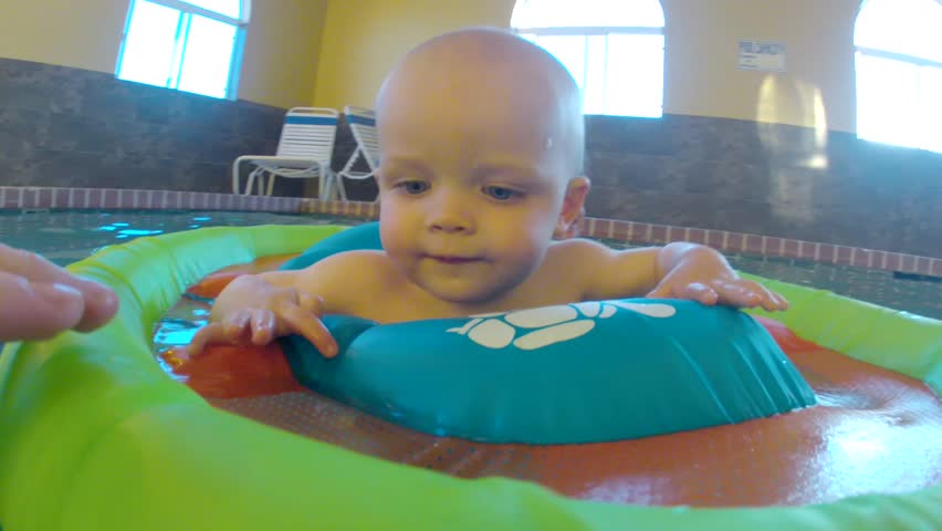 Underwater shot of a cute little baby boy at the swimming pool with his family.