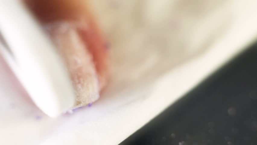 Woman removing the gel like nail polish, after it was soften by gel remover in other related stock video.