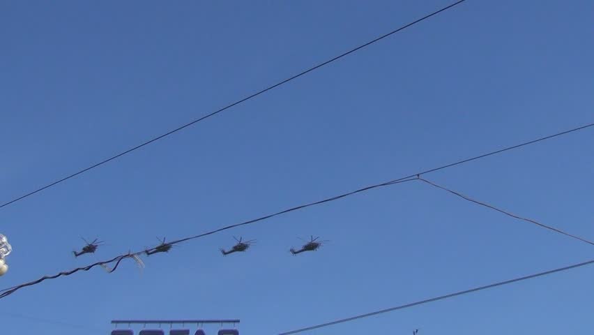 MOSCOW/RUSSIA - MAY 9: 4 Mil Mi-28 (Havoc) attack helicopters fly over wires on Tverskaya Street on display during parade festivities devoted to anniversary of Victory Day on May 9, 2013 in Moscow.