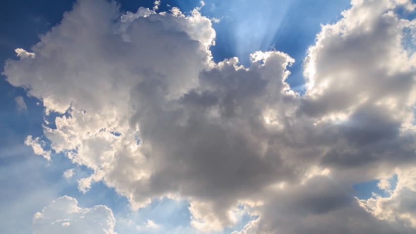 Sun ray shining through the clouds with blue sky timelapse