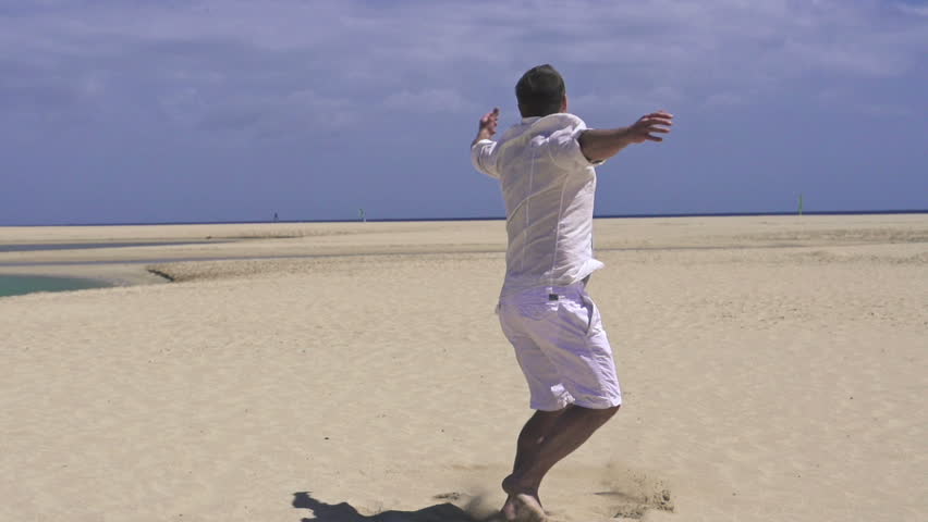 Young happy man having fun on the beach
