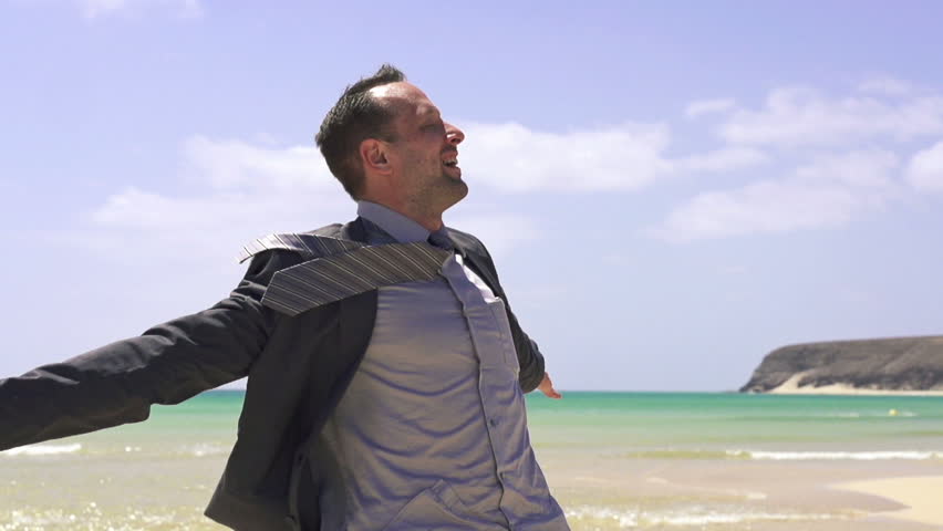 Happy businessman on the beach, super slow motion, shot at 240fps
