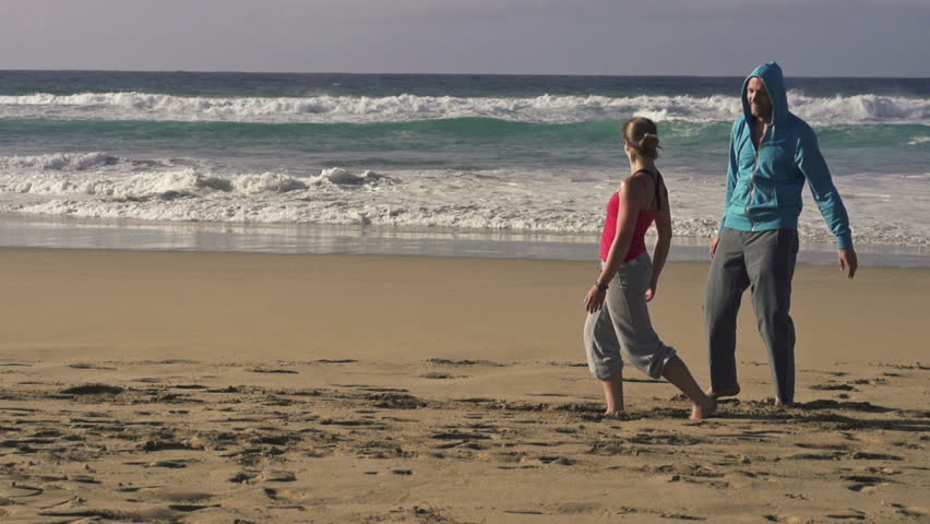 Tired joggers resting on beautiful beach, super slow motion, shot at 240fps
