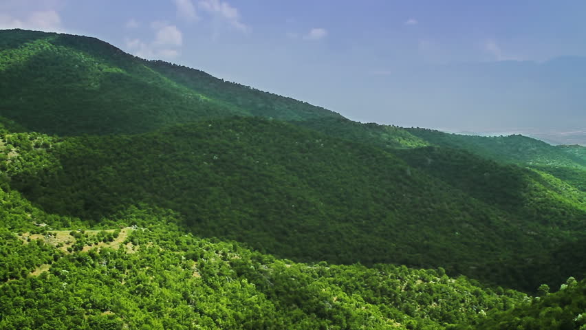 Timelapse of clouds shadow over mountain forest